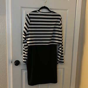 Two piece black dress with black and white long sleeve striped over-piece.